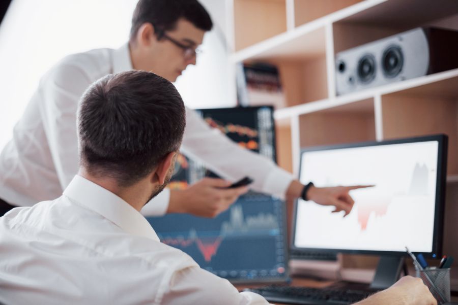 Team analyzing DOOH campaign reporting data and performance charts